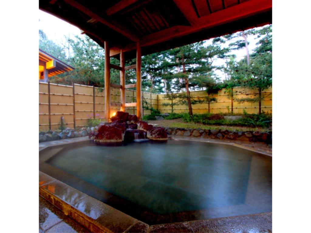 a pool in the middle of a patio at Yahatakan - Vacation STAY 99633v in Sado