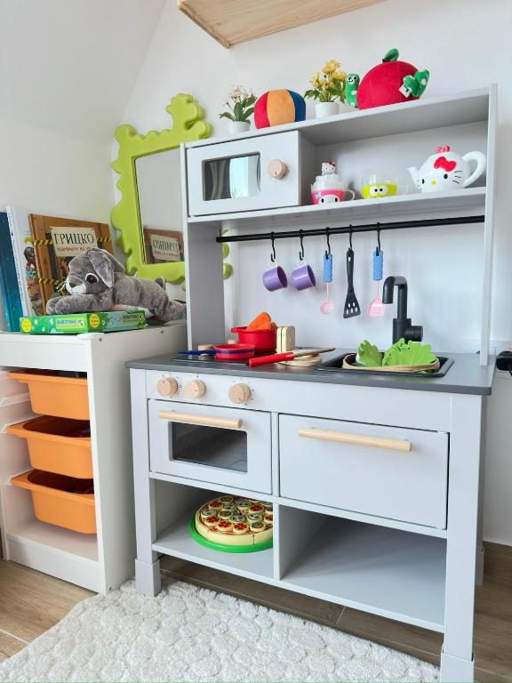 a pretend kitchen in a playroom with a pretend table at Dorin Kutak, Green Hills Divčibare in Divčibare