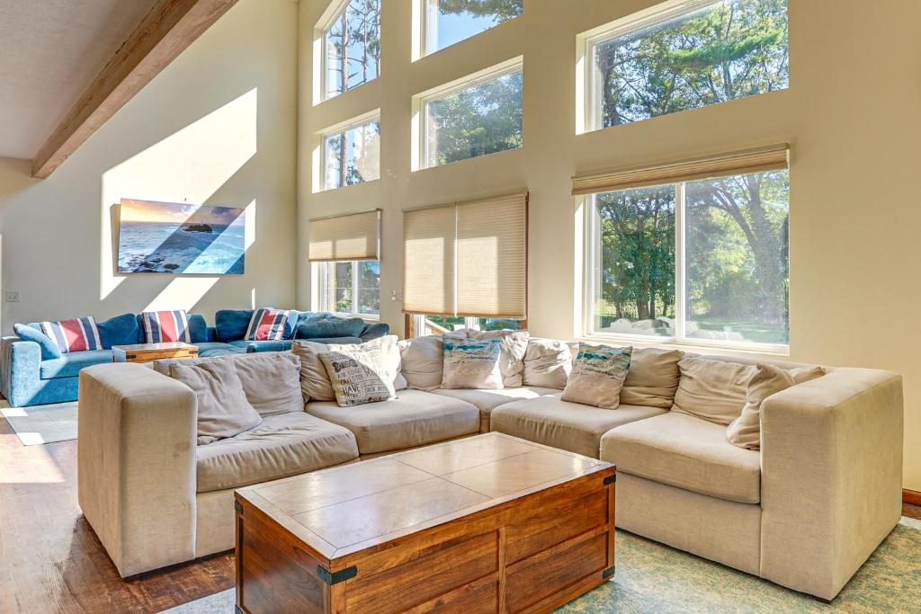 a living room with two couches and a table at Hot Tub and Game Room Spacious Whitehall Home! in Whitehall