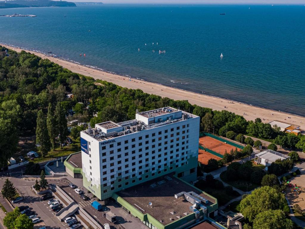 an aerial view of a building next to the beach at Novotel Gdańsk Marina in Gdańsk