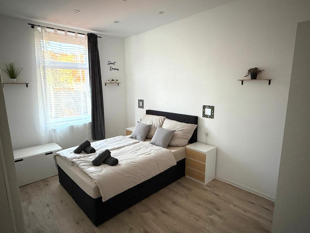 a bedroom with a bed with two towels on it at Ferienwohnung - schönes Heim Li-Apartments in Pforzheim