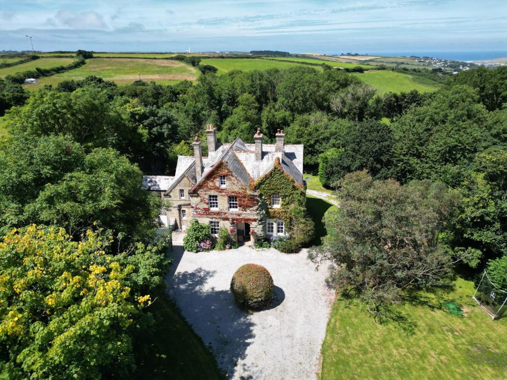 an old house in the middle of a field at The Old Vicarage in Truro