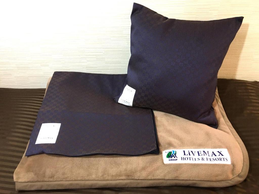 Postel nebo postele na pokoji v ubytování HOTEL LiVEMAX BUDGET Utsunomiya