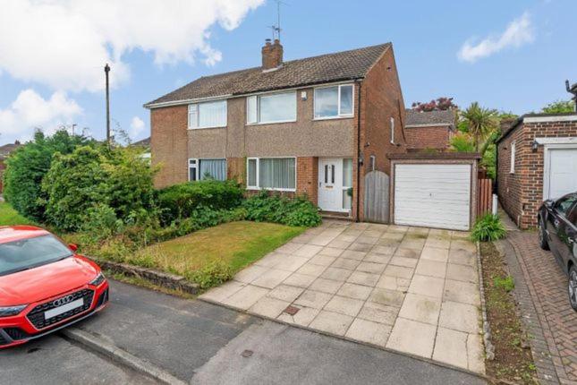 a red car parked in front of a brick house at Room self catering in Ossett