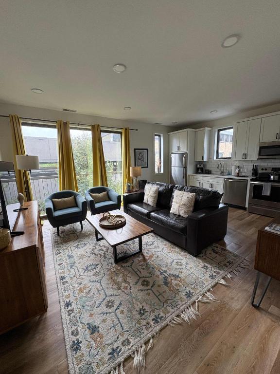 a living room with a couch and a table at Downtown Traverse City Capri Condo 316 in Traverse City