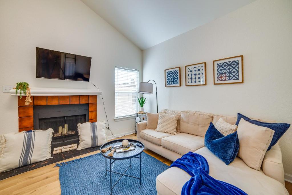 a living room with a couch and a fireplace at 3 Mi to Downtown Dallas Sleek Condo with Patio in Highland Park