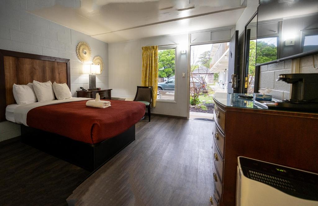 a hotel room with a bed and a kitchen at Heart of Manteo in Manteo