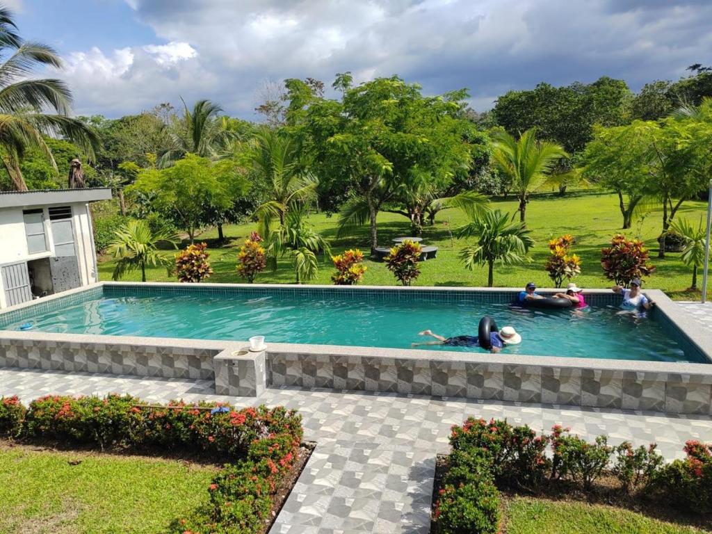 a group of people laying in a swimming pool at Quinta El Futuro in Esperanza