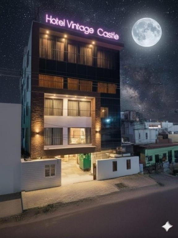 a building with a hotel viceroycesos castle at night at HOTEL VINTAGE CASTLE in Coimbatore