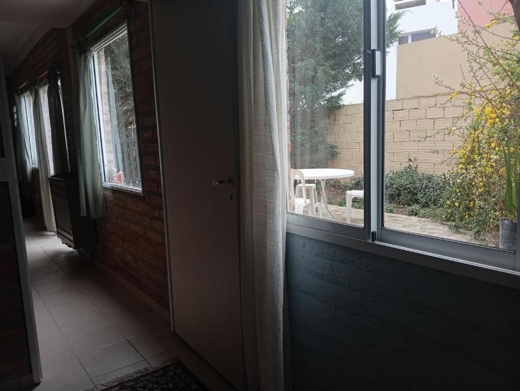 un couloir vide avec une fenêtre et une porte dans l'établissement Casa Boreal dptos estilo casa, à Puerto Madryn