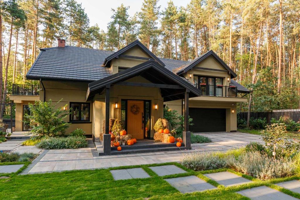 a house with pumpkins in the front yard at Villa Aleksandrow SPA in Aleksandrów