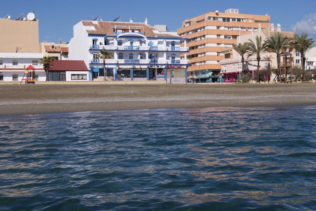 a view of a beach with buildings and the water at Hotel Doña Luisa in San Luis de Sabinillas