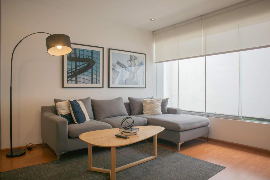 a living room with a couch and a table at Sleek 2BR in Miraflores in Lima