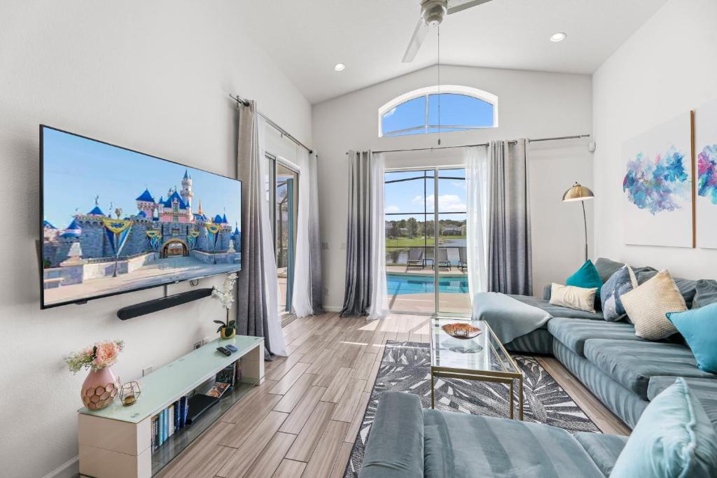 a living room with a couch and a tv at Family 4BR Private Pool BBQ Resort Stay in Kissimmee