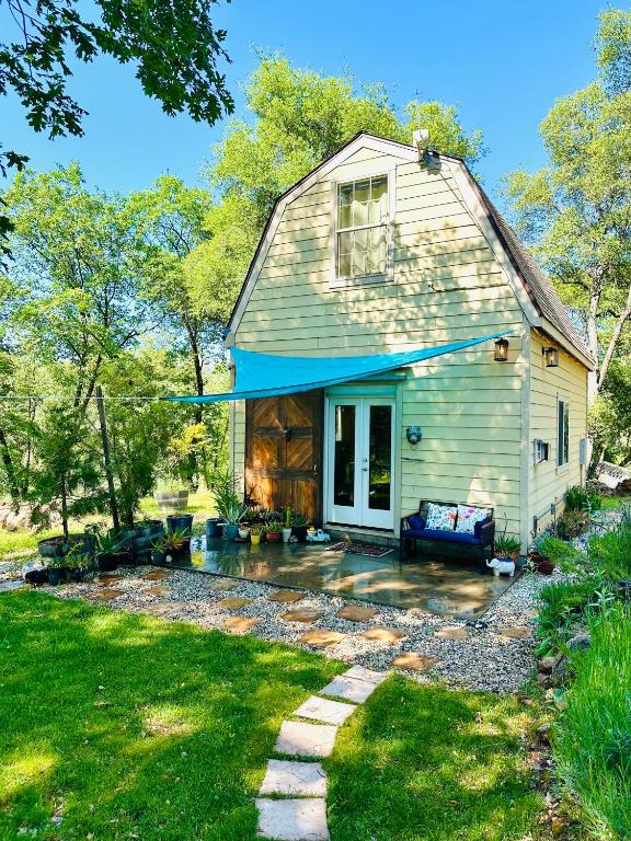 a house with a porch and a patio at Blissful Acres hilltop cottage in Grass Valley