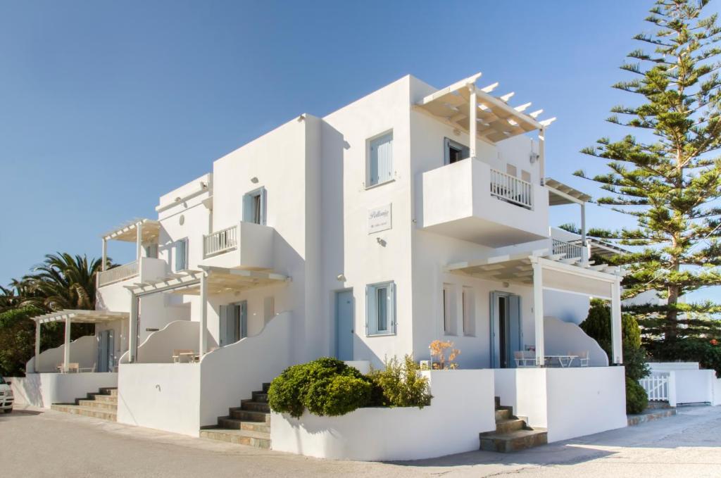 a white house with trees in front of it at Om Living Milos in Pollonia