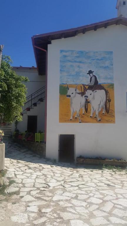 une peinture d'un homme faisant de l'équitation avec deux vaches dans l'établissement Fattoria la Cona, à Ascoli Piceno