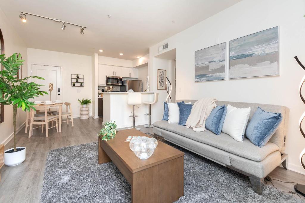 a living room with a couch and a table at Hollywood Stars Walk of Fame Apartment in Los Angeles