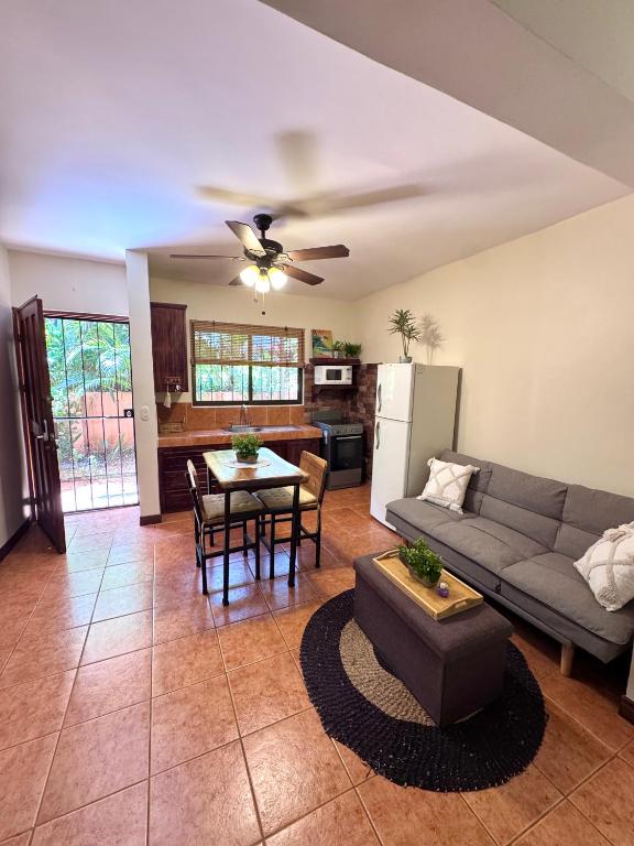 a living room with a couch and a table at Tiny Paradise Ground Floor Studio in Coco