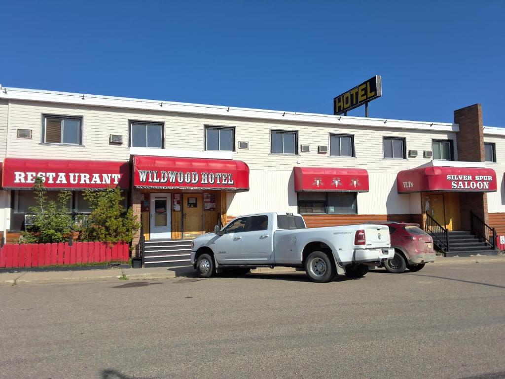 a white truck parked in front of a building at Wildwood Hotel in Wildwood