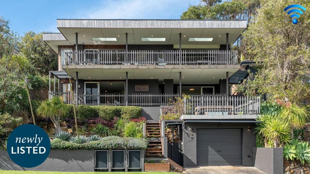 a large house with a balcony and a driveway at Surf N Turf in Kiama