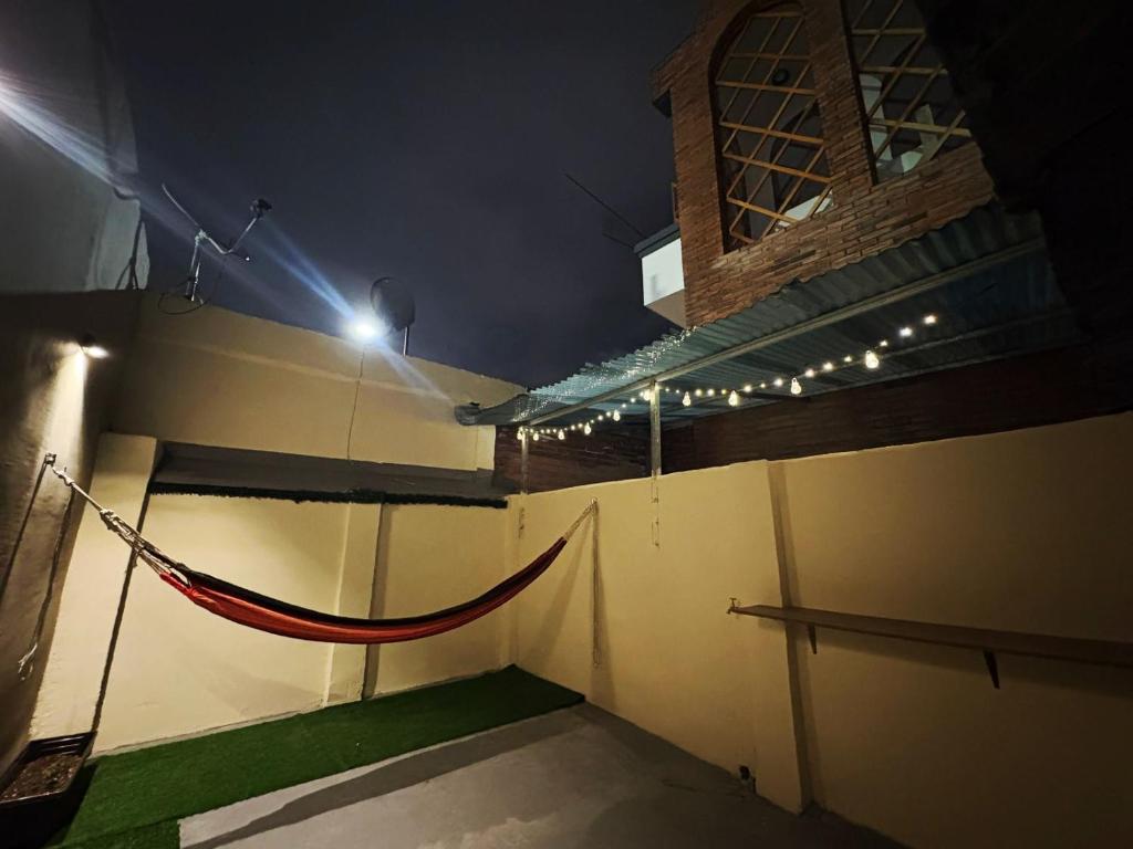 a building with a hammock on the side of it at night at INTI Entire apartment and private terrace in Quito