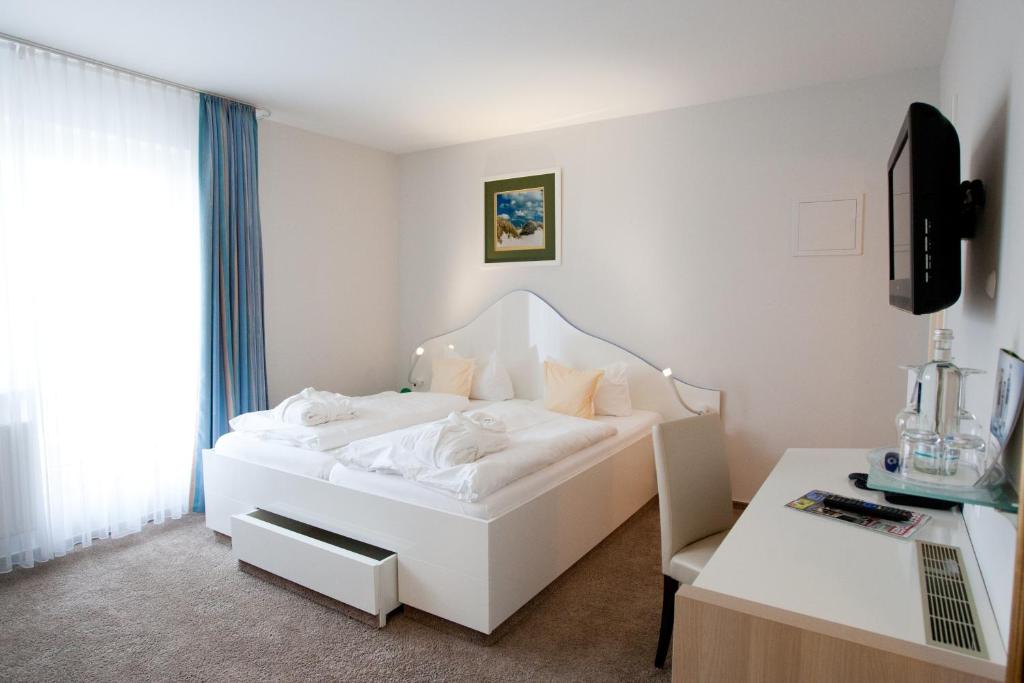Postel nebo postele na pokoji v ubytování Frühstückshotel Seemannsbraut Amrum-adults only ab 18 Jahre-keine Haustiere-