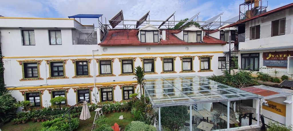 a large white building with a glass roof at Hotel Heranya in Kathmandu