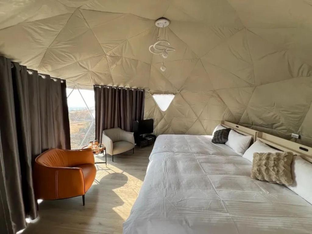a bedroom with a large bed in a tent at RUM ROSE BUBBLE lUXURY CAMP in Wadi Rum