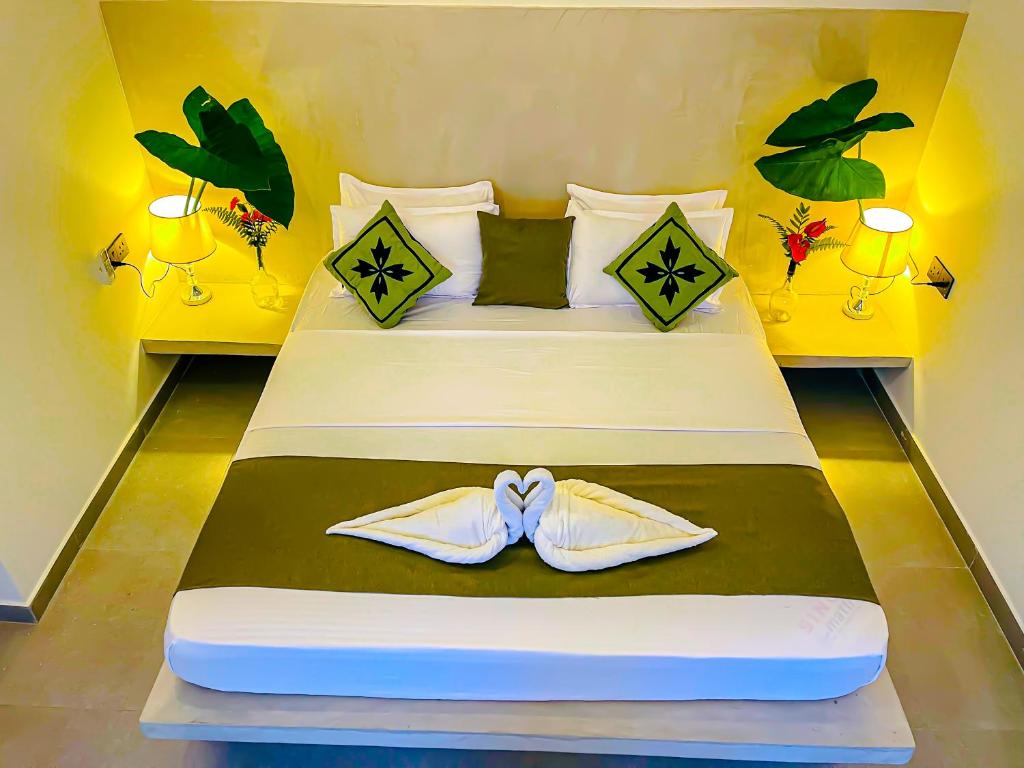 Un dormitorio con una cama con un par de zapatos encima. en The Mirror Wall Sigiriya, en Sigiriya