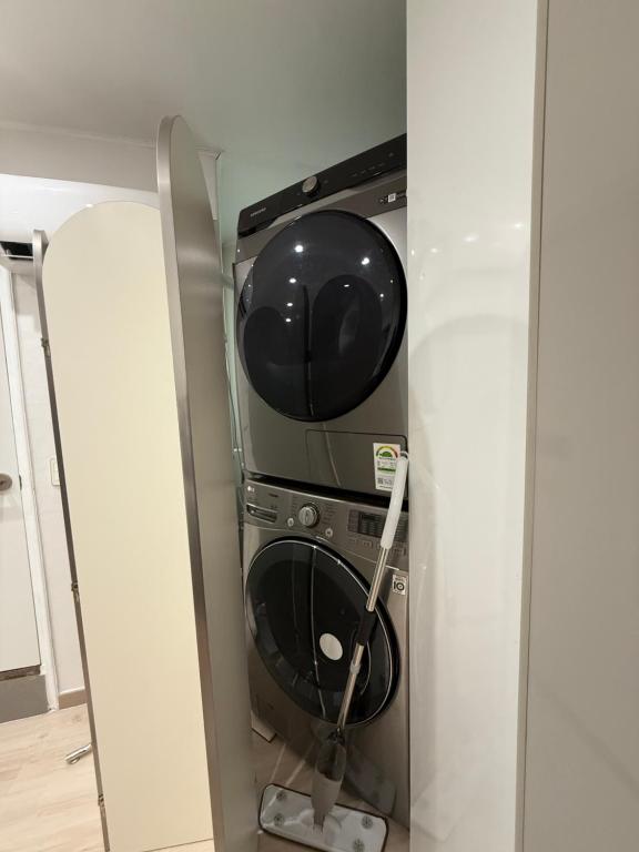 a washer and dryer in a corner of a room at Near Seoul Station, Myeongdong, Itaewon, N seoul tower in Seoul