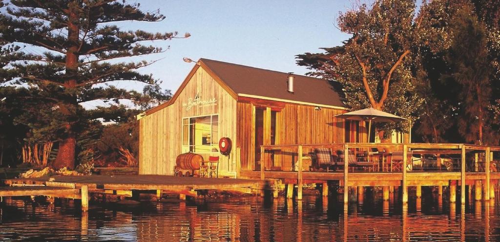 a house on a dock on a body of water at Boathouse - Birks River Retreat in Goolwa