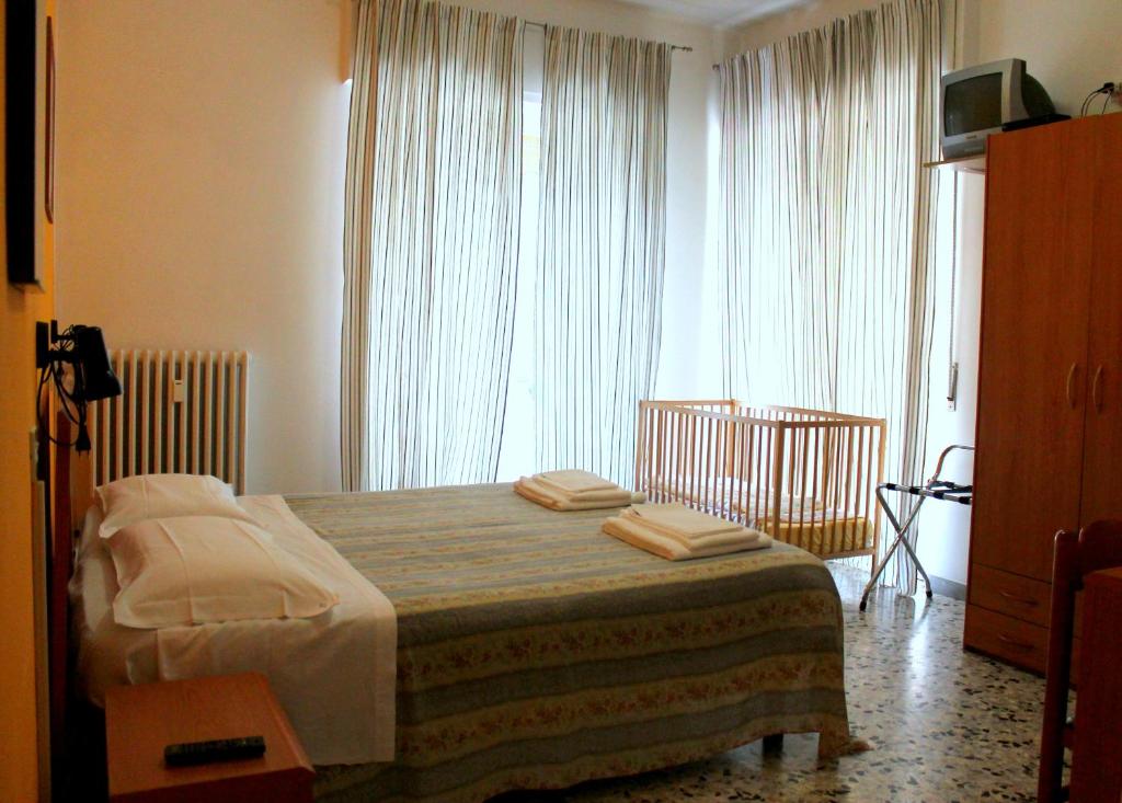 Postel nebo postele na pokoji v ubytování Albergo Nella