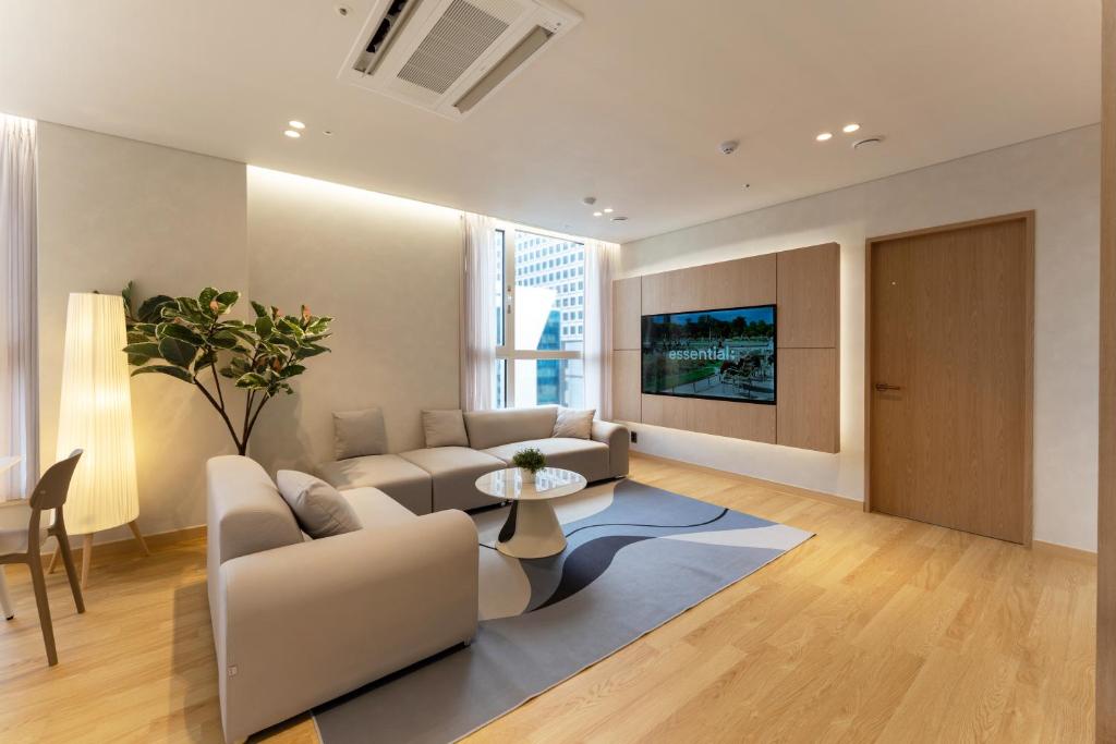 a living room with a couch and a table at MSstay Myeongdong in Seoul