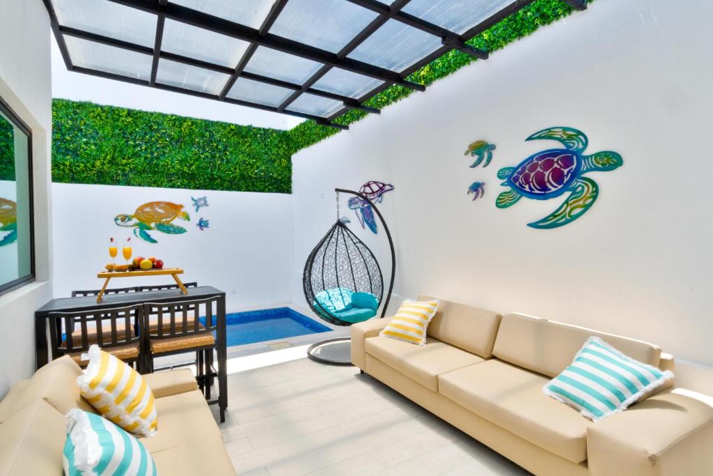 a living room with a couch and a turtle on the wall at Luxury home-heated Pool-2bedroom in Cancún