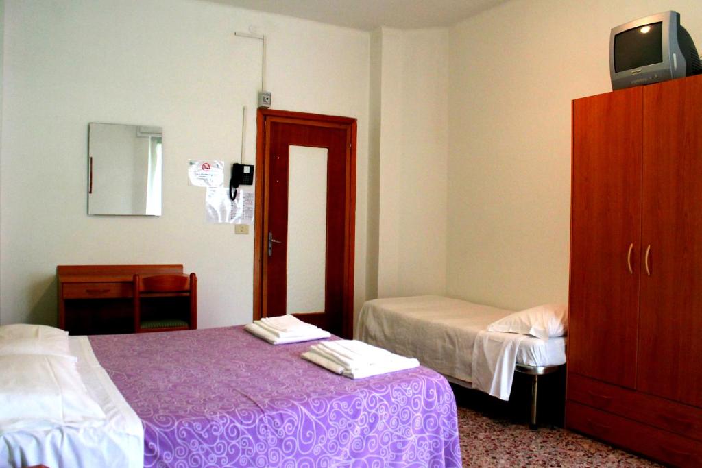 Postel nebo postele na pokoji v ubytování Albergo Nella