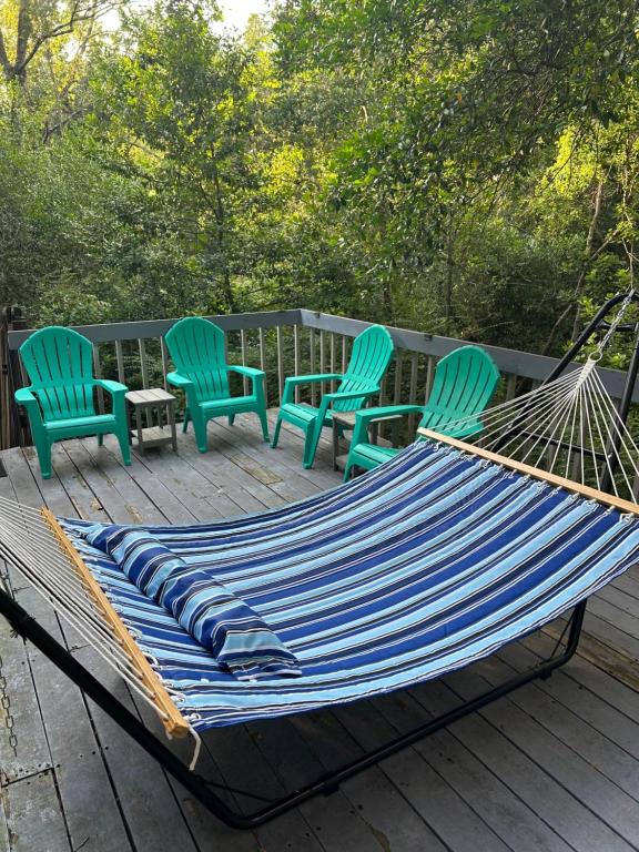 a hammock and four chairs on a deck at Willy Wonka House 1984 in Pensacola