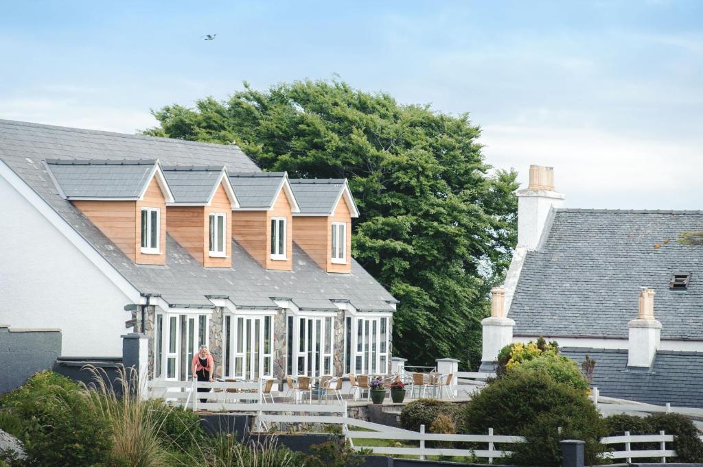 a person standing in front of a house at Kirklea Island Suites in Tarbert