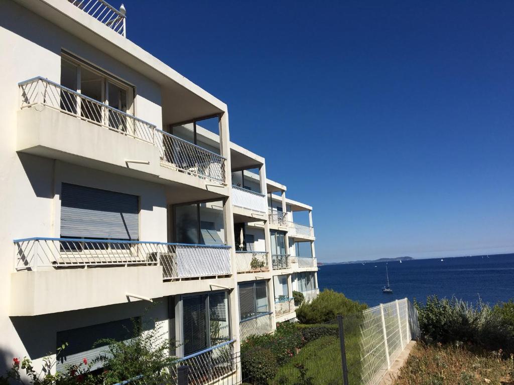 an apartment building with a view of the ocean at Appartement Le Cap in Toulon