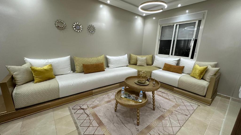 a living room with a white couch and a window at cozy appartement in Casablanca
