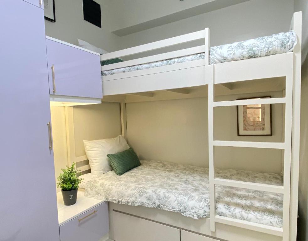 a bedroom with a bunk bed and a desk at Luxe Living in Iloilo City