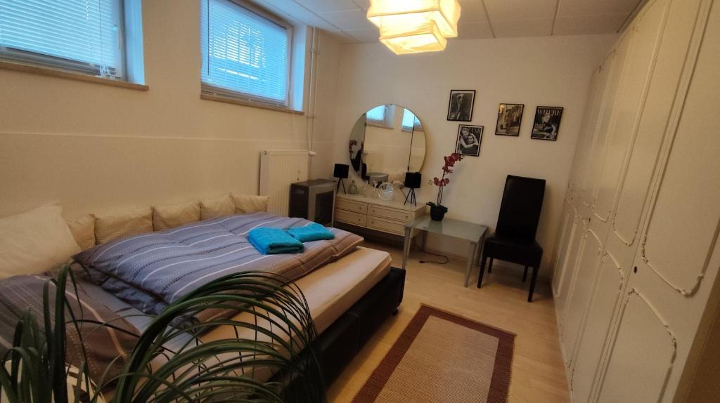 a bedroom with a bed and a desk and a mirror at Lamonte in Munich