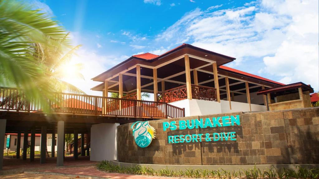 a resort building with a sign in front of it at PS Bunaken Resort and Dive in Bunaken