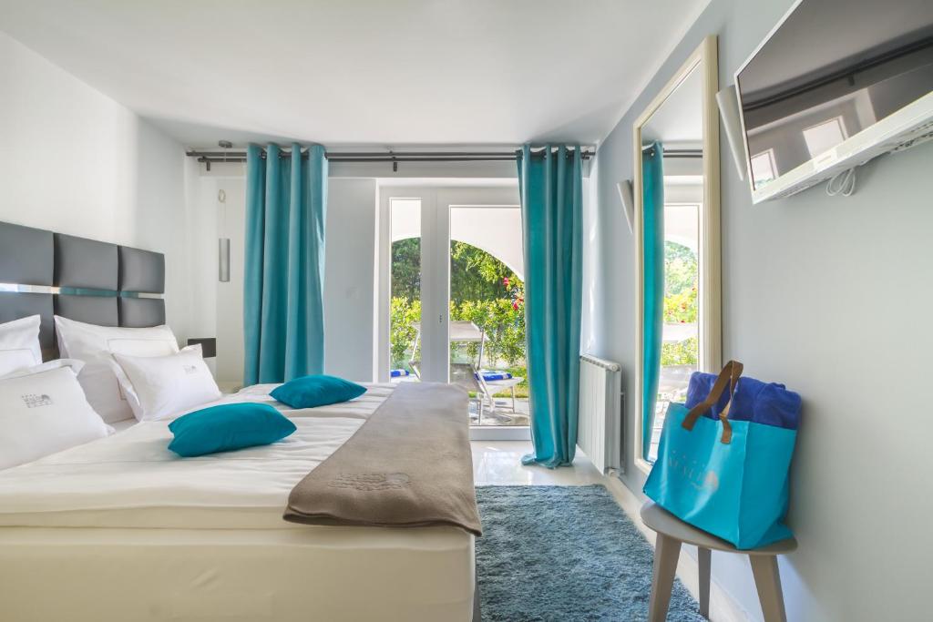 Postel nebo postele na pokoji v ubytování Hotel Malin