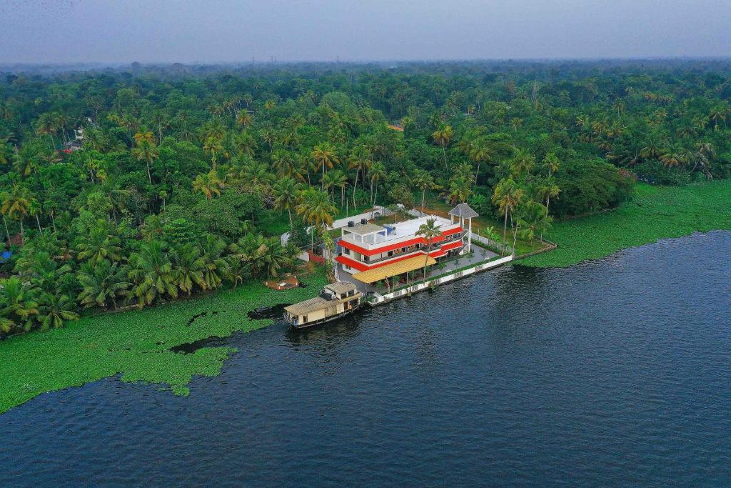 a house on a dock in the middle of the water at Vembanad Village Backwater Resort by EGH in Alleppey