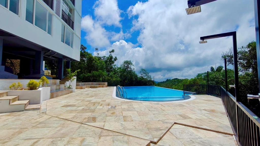 a swimming pool on a patio of a building at Vanaheim Resort in Vagamon
