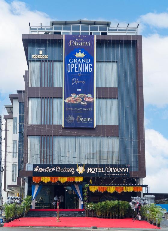 a building with a sign on the side of it at Hotel Diyanvi in Mysore