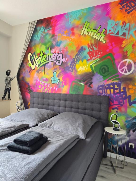 a bedroom with a painting on the wall at Piste und Pedale , Deine Bude-Dein Abenteuer in Winterberg