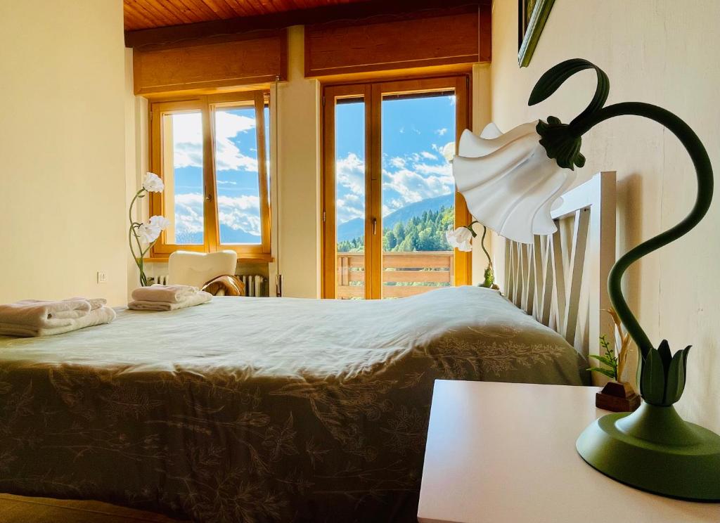 a bedroom with a bed with a view of a mountain at Casa DaRin in Vigo di Cadore