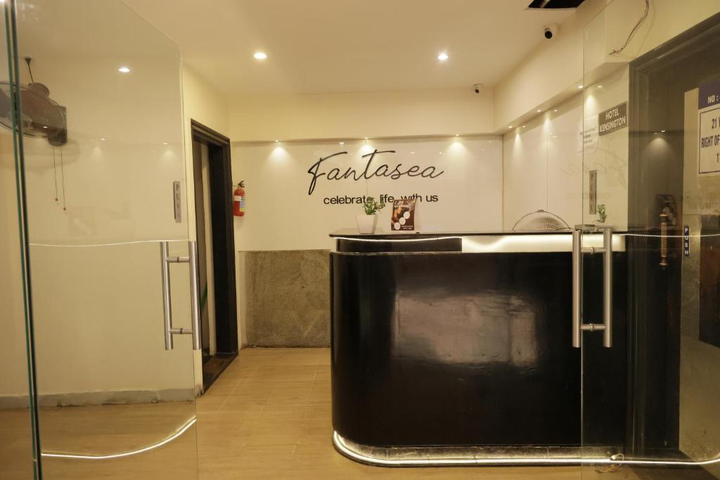 a room with a counter with a sign on the wall at Serene Stays in Chennai